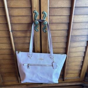 Coach pink tote with floral lining inside.